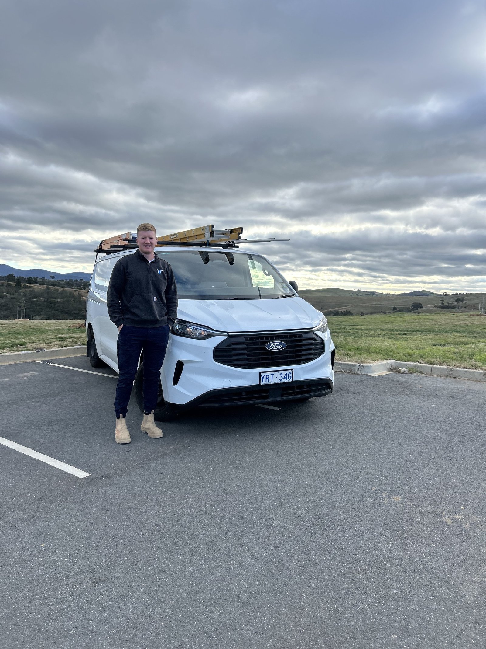 Tom Tyrrell beside his work van in Canberra